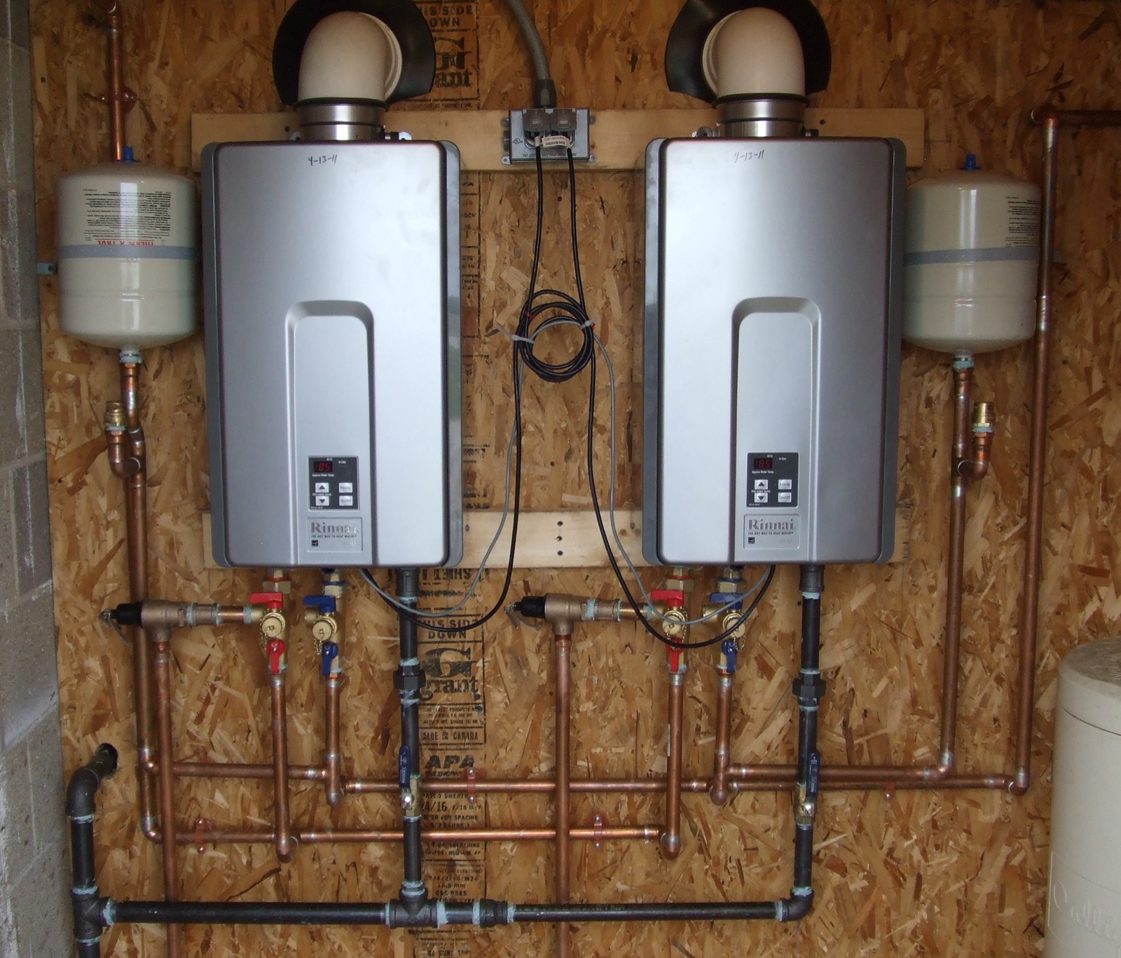 Two tankless water heaters installed on copper manifolds